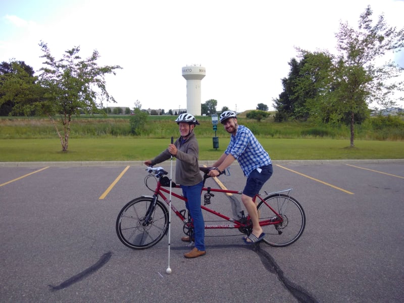 Chris takes the pilot position on the tandem complete with white stick!