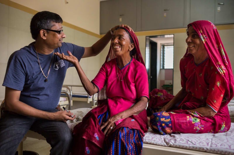 Dr. Shah screens woman in Siliguri, India Clinic