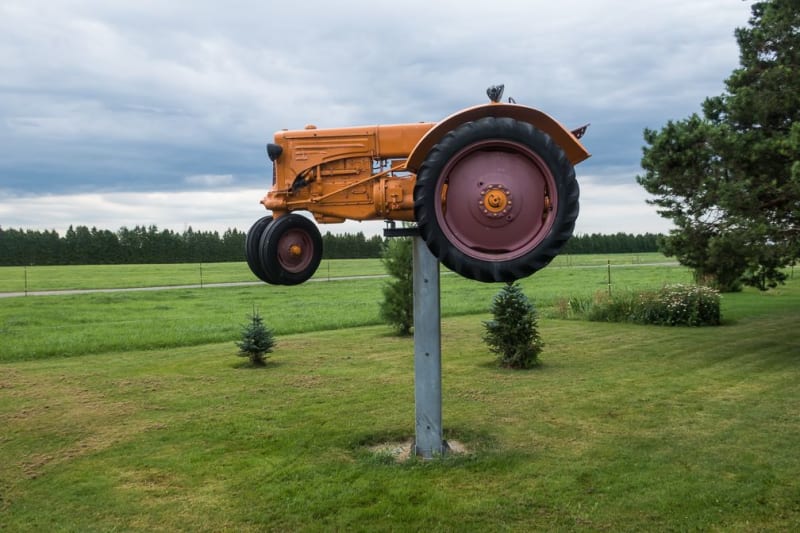 A tractor raided off the ground on a metal pole